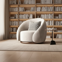 Fauteuil d'appoint en velours caramel, style Japandi, design enveloppant rond avec base en anneau doré pour salon