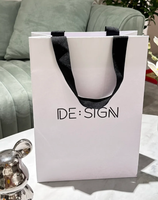 Vente en gros Sac en papier de luxe imprimé personnalisé pour vêtements et bijoux avec papier d'art avec logo de marque et poignée promotionnelle