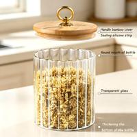 Pot de conservation en verre borosilicate à rayures verticales rondes de 500 ml avec couvercle en liège et bambou.