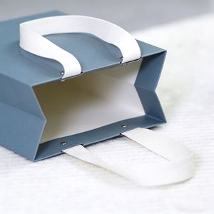 Sac en papier bleu pliable pour le commerce de détail, avec poignée en coton recyclé et design perforé à rivets, personnalisable - Product Image 3