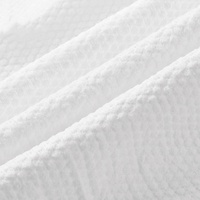 Serviettes de bain compressées jetables en non-tissé écologiques, douces et pratiques pour l'hôtellerie
