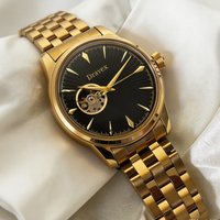 Montre automatique rétro à cadran noir brillant effet rayons de soleil, mouvement apparent, bracelet en acier inoxydable doré pour homme