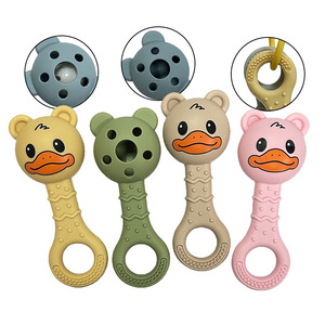 Jouets de dentition en silicone colorés en forme de canard avec anneau de maintien pour bébés, anneaux de dentition souples en caoutchouc à mâcher en jaune, vert, beige, rose - Product Image 1