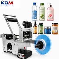 Etiqueteuse de bouteilles rondes semi-automatique de bureau KDM-SL50 pour les contenants de cosmétiques, d'huiles essentielles et de soins personnels
