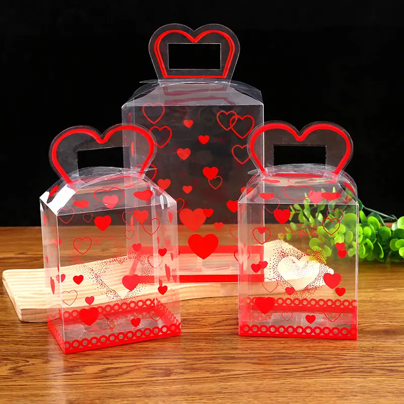 กล่องของขวัญลูกกวาดเค้กดอกไม้ใสสำหรับวันวาเลนไทน์พร้อมที่จับพลาสติกรูปความรัก