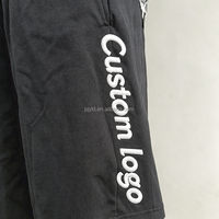 Shorts en molleton de coton noir à ourlet brut, coupe ample, avec logo brodé personnalisé OEM ODM, taille élastique, pour hommes