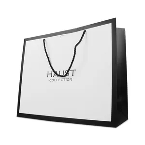 Vente en gros d'emballage en carton avec logo personnalisé sac en papier blanc noir de cadeau à provisions de luxe pour bijoux avec poignées sac de papel