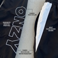 Pantalon de survêtement ample à rayures latérales contrastées en nylon technique résistant à l'eau, avec grand motif, pour tenue streetwear urbaine