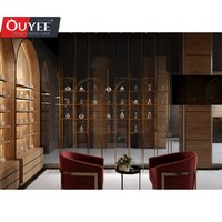 Comptoir présentoir de parfums en marbre au design d'intérieur Parfumerie unique Vitrine murale arquée en placage de bois pour parfumerie avec lumière LED