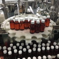 Ligne de production de remplissage, de bouchage et d'étiquetage de bouteilles en PET, machine de remplissage de liquides de 100 ml, ligne de production de remplissage de sirop contre la toux