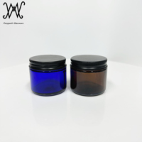 Botol krim kaca amber bulat 2 oz 60ml dengan tutup logam hitam matte untuk makeup Losion eye shadow