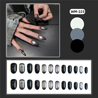 Faux ongles en acrylique noir effet œil de chat brillant, forme ovale longue avec dégradé argenté scintillant, paillettes foncées pour une esthétique audacieuse