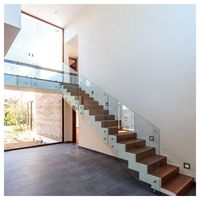 Escalier courbé sur mesure Prima en acier au carbone avec balustrade en verre, escaliers flottants pour villa, escalier courbé