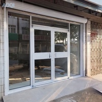 Porte extérieure commerciale en verre coloré laminé, à double charnière, avec cadre en alliage d'aluminium, idéale pour les hôpitaux et les hôtels
