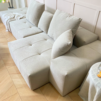 Canapé d'angle moderne inclinable avec rembourrage capitonné, emballé sous vide et compressé directement de l'usine, idéal pour appartement et salon
