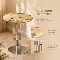 Table basse ronde moderne en marbre écologique de luxe avec base en colonne métallique pour salon et hôtel
