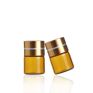 Pequeño frasco redondo de vidrio ámbar para aceites esenciales, cosméticos, vacío, de 1 ml, con tapa de rosca de aluminio dorado y plástico. - Product Image 3