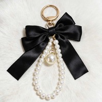 Porte-clés créatif polyvalent avec nœud papillon et petites perles, pendentif pour sac de téléphone portable pour femme