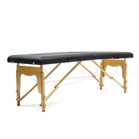 Table de massage thaïlandaise pliable portable en promotion, design moderne, cuir noir, pieds en bois, pour salon, cils, lit de massage, usage hôtelier