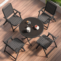 Table pliante en verre trempé avec structure en métal + 2 chaises pliantes avec structure en métal et assise en PP, idéale pour les jardins, les plages, les cafés en plein air