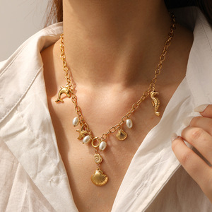 Collana con ciondoli a forma <span class=keywords><strong>di</strong></span> stella marina, cavalluccio marino e delfino in acciaio inossidabile anallergico, placcata oro, con conchiglia e nappa, stile marino - Product Image 1