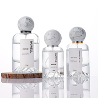 Bouteille de parfum ronde de fond de montagne de volcan de 50ml bouteille en verre de pulvérisateur à sertir vide clair avec couvercle à bille en résine de luxe