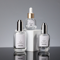 Flacon compte-gouttes ovale en verre transparent avec bouchon compte-gouttes métallique pour emballage de sérum essentiel pour le visage et cosmétiques de marque