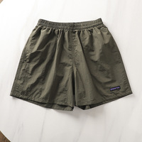 Usine OEM personnalisé taille élastique vêtements d'entraînement vêtements de plage de course Gym Nylon rue Shorts de plage de bain pour hommes