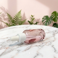 Flacon compte-gouttes en verre rose transparent personnalisé avec logo, forme cylindrique minimaliste, pour cosmétiques de voyage