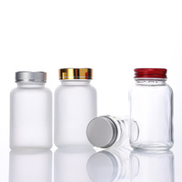 Vente en gros de pots de stockage de pilules en verre transparent givré de petite capacité 60cc 75cc 100cc avec couvercles à vis pour capsules, comprimés de vitamines