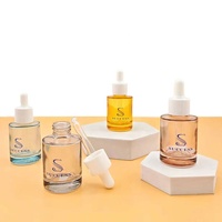 Flacon compte-gouttes en verre noir 30 ml vide pour huiles essentielles et sérums, avec bouchon doré et pompe en caoutchouc blanc, vente en gros, logo personnalisé