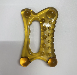 Planche Gua Sha en résine couleur ambre en forme d'os - Product Image 1