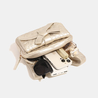 Sac à dos en PU avec nœud pour femme, nouvelle collection été 2024, petit sac de voyage haut de gamme à bandoulière unique avec chaîne, fermeture éclair