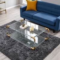Table basse décorative de luxe à deux niveaux en verre trempé transparent avec cadre en acier inoxydable argenté et pieds en acrylique pour salon