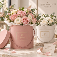Boîte cadeau cylindrique rigide en carton texturé avec poignée en corde ronde, couvercle et base personnalisés avec logo, pour l'emballage de fleurs