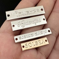 Étiquettes métalliques de conception tendance gravées au laser en alliage de zinc Consen Professional pour accessoires vestimentaires