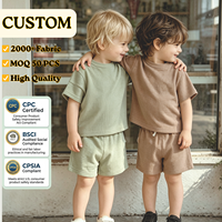 Ensemble de vêtements pour bébé et enfant unisexe personnalisé en coton gaufré uni avec manches courtes et étiquette
