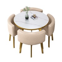 Table à manger ronde de luxe légère avec cadre doré et chaises rembourrées pour salon