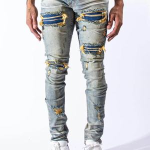 กางเกงยีนส์เดนิมทรงสกินนี่สีน้ำเงินแบบวินเทจ ดีไซน์เนอร์คุณภาพสูง ขายส่ง แบบสั่งทำพิเศษ ขาดเซอร์ๆ แต่งผ้าปะติดปะต่อ สำหรับผู้ชาย - Product Image 2