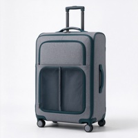 Valise à roulettes souple grise et turquoise avec compartiment avant zippé, deux poches en filet et poignée télescopique
