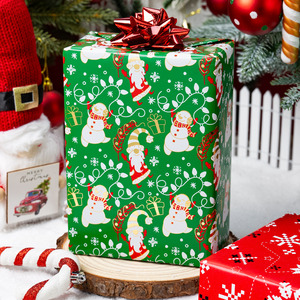 Rollo de Papel de Regalo Navideño Reversible de 17 Pulgadas x 33 Pies, Dorado Metálico con Diseño de Gnomos y Muñecos de Nieve con Copos de Nieve Verdes - Product Image 1