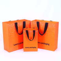 Sac en papier de luxe avec logo personnalisé Sacs cadeaux en papier noir mat à provisions avec poignée en ruban