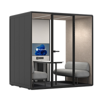 Cabine de travail modulaire intérieure moderne avec table, canapé et éclairage LED pour discussion d'équipe, pod de réunion insonorisé