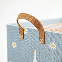 Panier de rangement pliable en lin bleu clair avec imprimé marguerites et oies, poignées en tissu renforcé pour l'organisation de la chambre d'enfant et du placard