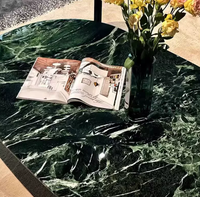 Table basse ovale minimaliste en marbre italien pur, légère et luxueuse, pour salon moderne et élégant.
