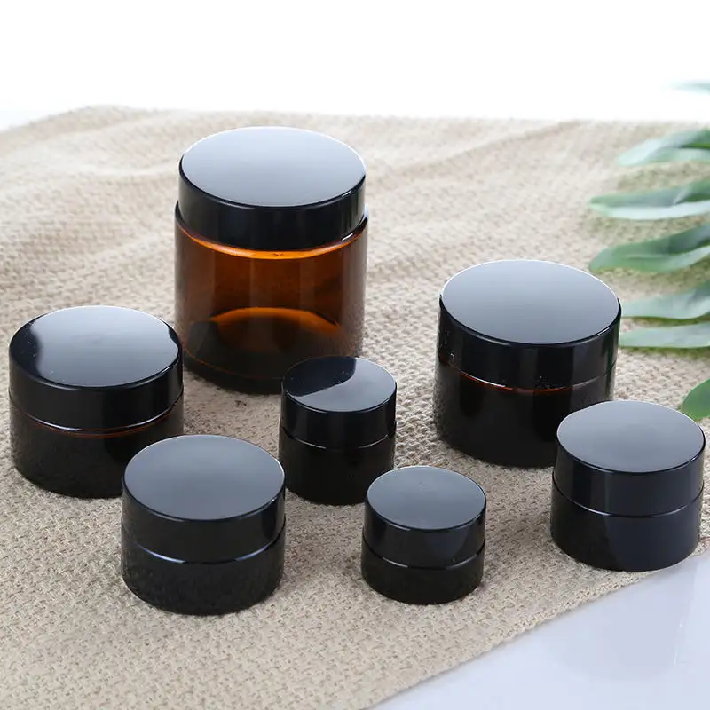 Premium lüks yuvarlak kozmetik konteyner doldurulabilir boş Mini göz kremi yüz kremi 5g 10ml Amber cam kavanoz siyah kapaklı