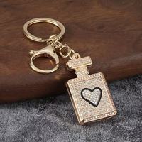 Porte-clés mousqueton en alliage léger et étanche, avec pendentif décoratif en forme de flacon de parfum orné de strass, pour femme, vente en gros, cadeau