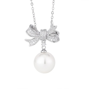 Wholesale Fashion Eco-friendly Copper 14-12mm White Shell Pearl Bow Design Anti Tarnish <b>Earring</b> Necklace <b>Set</b> for Women - Product Image 2