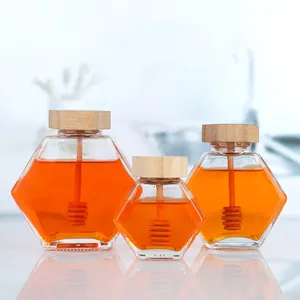 Großhandel 100-300ml Sechseckige Honig marmelade Lagerung mit Holzdeckel Glasflasche in Lebensmittel qualität Versiegelte Dosen Honig gläser Mit Misch stab
