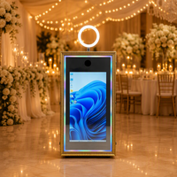 Photomaton intégré dans un cabinet, style borne interactive, avec éclairage RGB et imprimante dissimulée, idéal pour les événements commerciaux